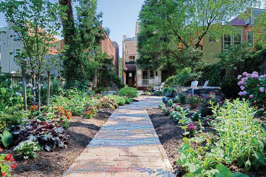 Backyard – ClearView Communities backyard with bricked walkway surrounded by beautiful plants and flowers - ClearView - Maryland Community-Based Psychiatric Health Treatment
