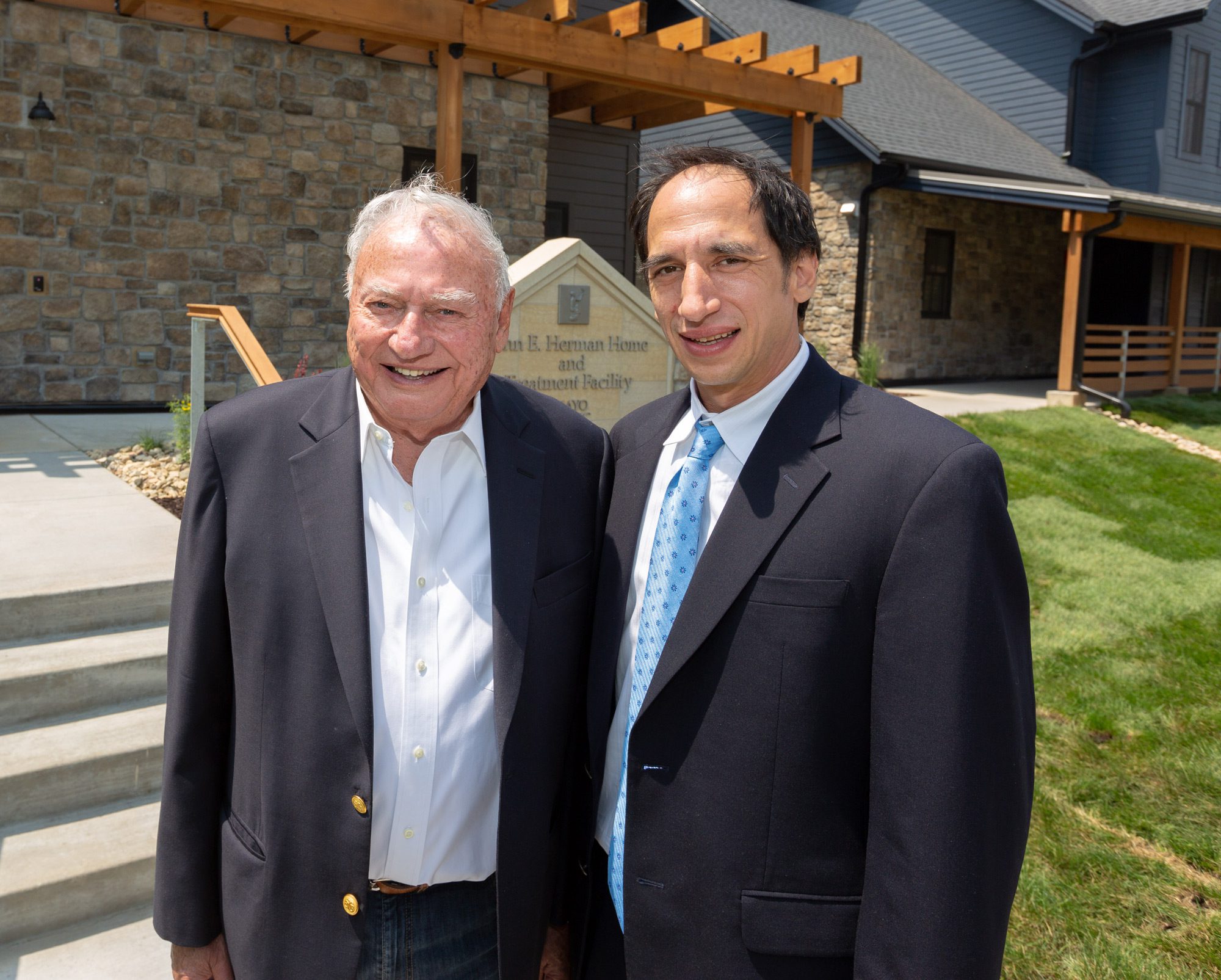 Chic and John Herman Chic and John Herman standing in front of the John E. Herman Home and Treatment Facility